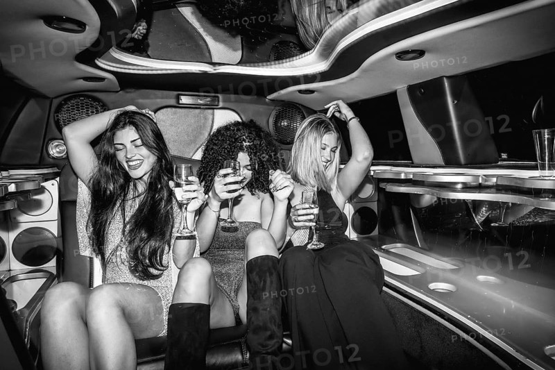 Three young women celebrating a special occasion, traveling in a luxurious limousine, enjoying drinks and dancing, symbolizing friendship, success, and glamorous nightlife