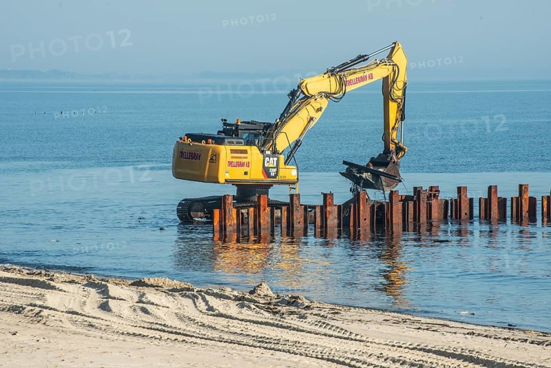 Excavator used in the repair and construction of bathing jetties at Ystads Saltsjöbad, the beach in Ystad, Ystad, Skåne County, Baltic Sea, Sweden, Scandinavia