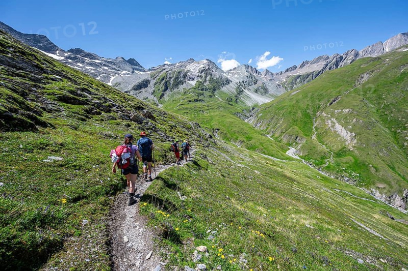 Three mountaineers on a hiking trail, view of rocky mountain peaks in the Karbach valley with Tredebergspitze, Lasörling Höhenweg, Lasörling Group, Hohe Tauern National Park, East Tyrol, Tyrol, Austria