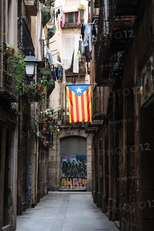 A flag of the Estelada of the Catalan Nationalists in an alley of the historic centre of Barcelona, Spain