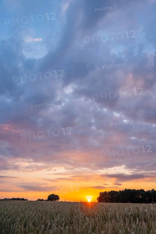 Romantic sunset over fields and meadows with colorful clouds in early summer, Upper Palatinate, Bavaria, Germany