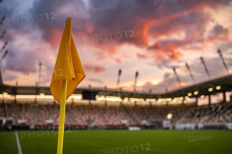 Corner flag at the football stadium and dramatic colorful sky in the background in Lubin, Poland