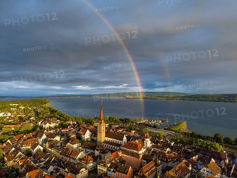 Aerial view of the historic old town of Radolfzell am Lake Constance with the cathedral illuminated by the evening sun, behind it a rainbow, district of Konstanz, Baden-Württemberg, Germany
