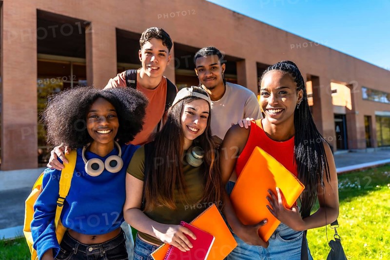 Diverse group of university students smiling together on campus, enjoying friendship, teamwork and learning outdoors multiethnic, casual, backpacks and books, bright college life