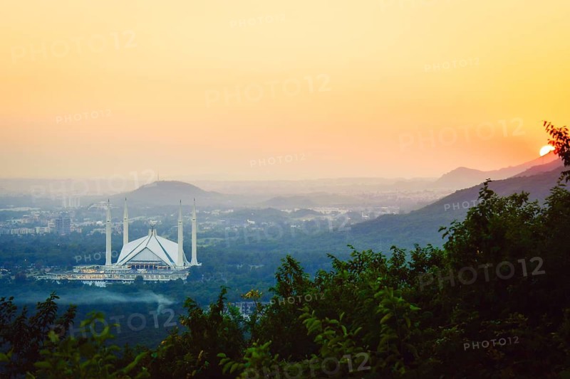 Islamabad, Pakistan - 12th september, 2023: The Faisal Mosque - fifth-largest mosque in the world. Major tourist attraction in Pakistan. Margalla hills famous sunset viewpoint panorama