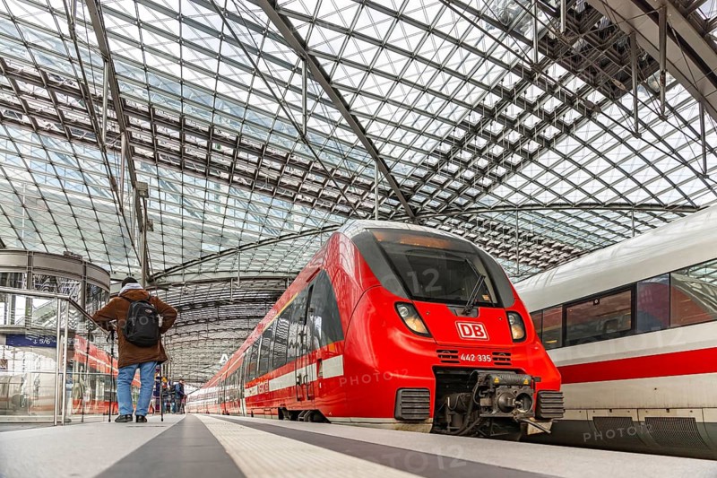 Berlin main station with regional train and ICE. Travelers on the platform. Berlin, Germany