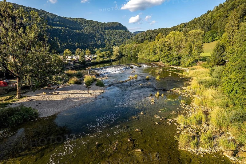 Camping site Moulin du Doubs and weir at the river Doubs near Ocourt seen from the air, Switzerland