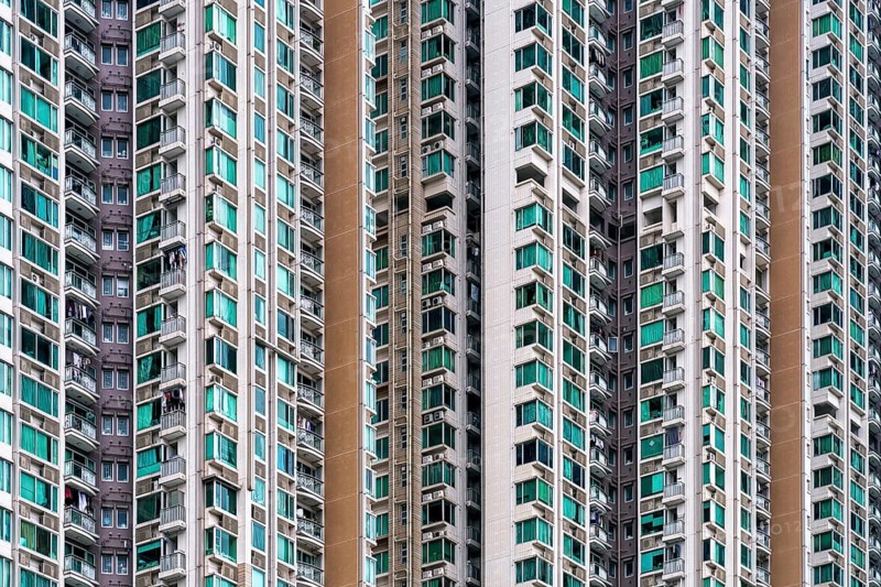 Close-up view of numerous high-rise residential towers densely packed in Hong Kong, showcasing the city's vertical living spaces and architectural density