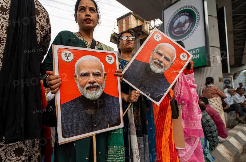 Supporters hold placards featuring Narendra Modi during a public rally of the Bharatiya Janata Party ahead of the Assam Assembly Election 2026 in Guwahati, India on 28 March 2026