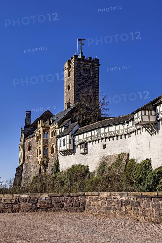 Historic castle with stone walls and banner, Wartburg Castle near Eisenach in Thuringia