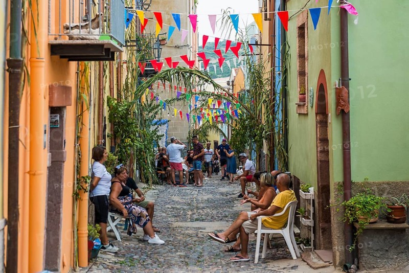 Children playing and colourful houses, Bosa, district of Oristano, Sardinia, Italy