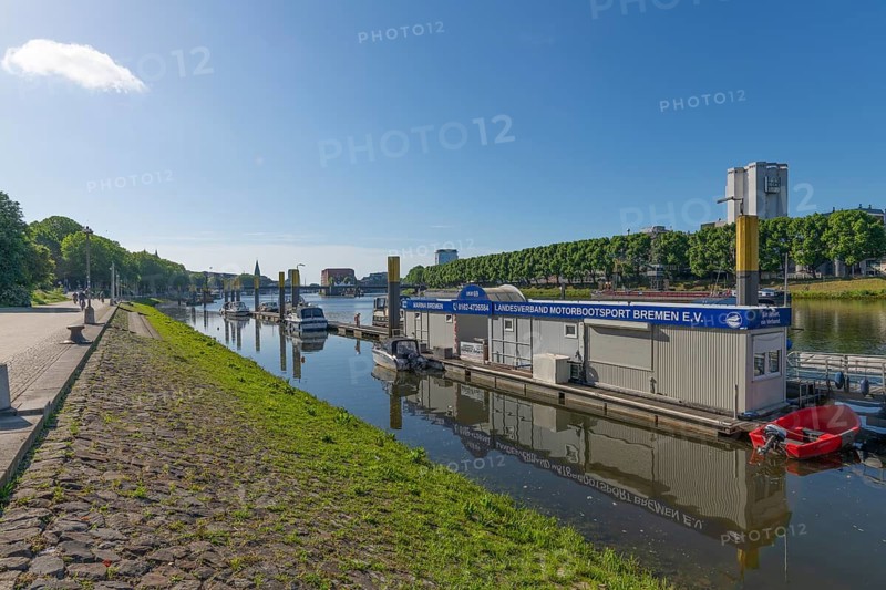 Port of Motorsportboot Bremen e.V. on the Weser, Hanseatic City of Bremen, city skyline, Weser promenade for cyclists and pedestrians, shore, pier with building, water reflection, motor boats, sports, leisure, fun, tree-lined avenue, Beck's beer, silos, blue sky, Germany
