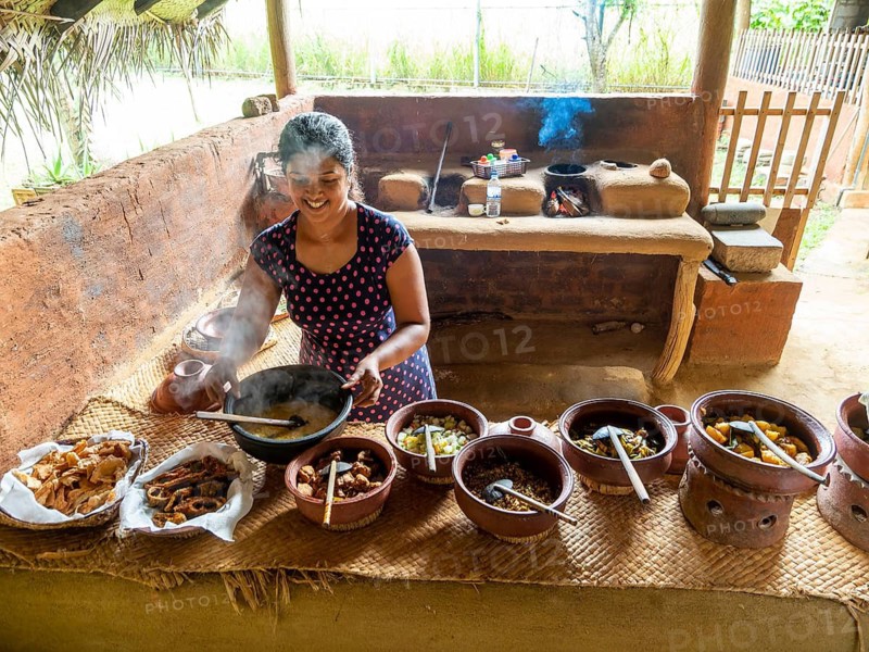 Sinhala woman prepares lunch in clay pots, Sri Lanka