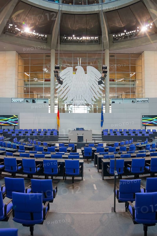 Modern plenary chamber with blue chairs and large eagle emblem, German and European flags, Reichstag building, German Bundestag, Berlin, Germany