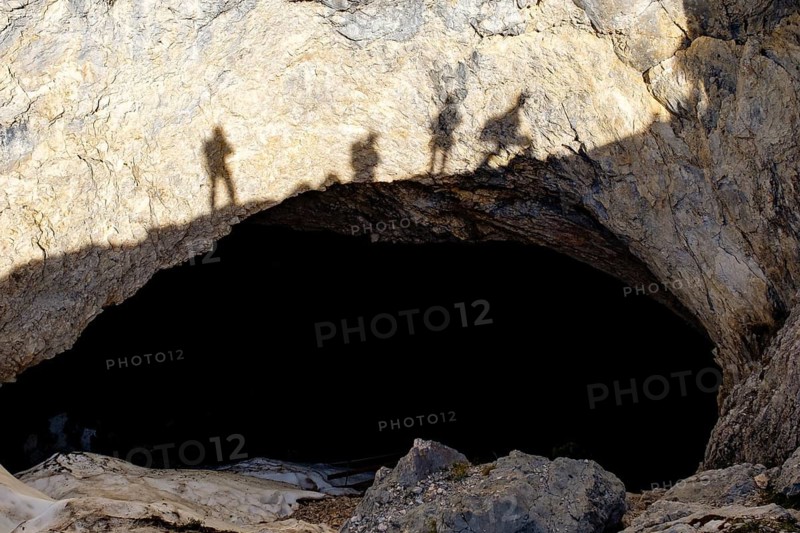 Shadow of cave rescuers on the rock above the cave entrance of the Schellenberg Ice Cave, Marktschellenberg, Berchtesgadener Land, Upper Bavaria, Bavaria, Germany