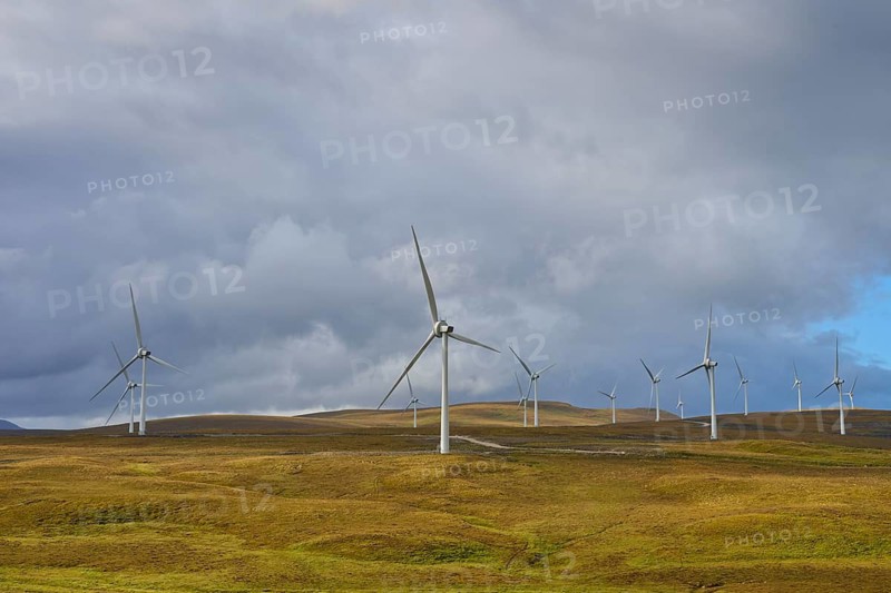 Wind turbines on green hills under a cloudy sky, Lairg, Scotland, United Kingdom, United Kingdom