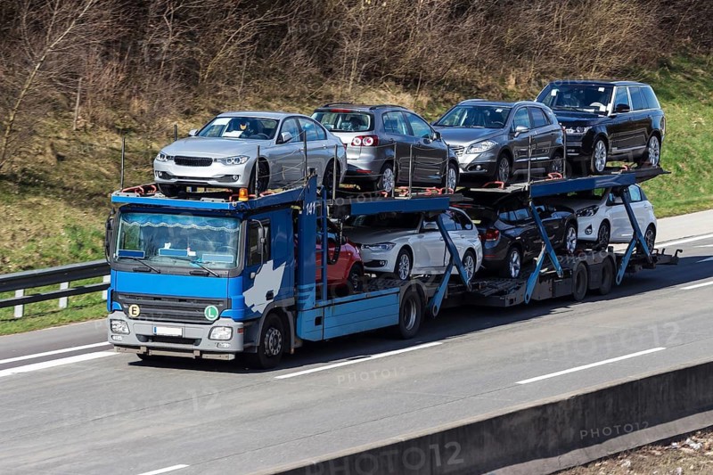 A lorry transports several new cars, car transporter on the A1 motorway, Federal Republic of Germany