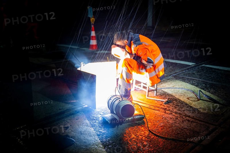 Worn tram tracks are made fit for traffic using construction welding. In order not to disrupt traffic too much, this work is carried out at night by a construction crew, Dresden, Saxony, Germany