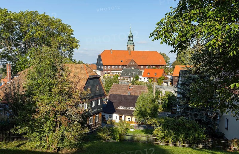 Striking view of the village with church, Niederkretscham nature park Park House and typical Umgebinde houses in Waltersdorf, Großschönau, Saxony, Germany