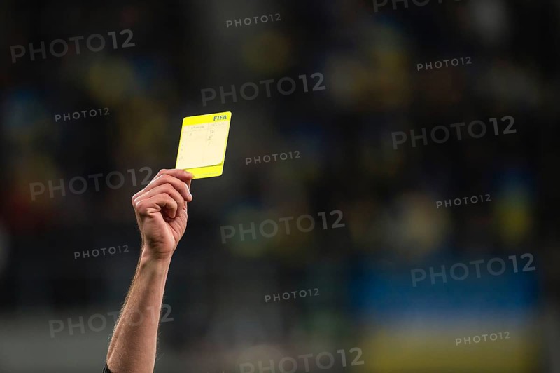 WROCLAW, POLAND - MARCH 26, 2024: Qualifications for UEFA Euro 2024. Final play-off match Ukraine - Iceland 2:1. Referee shows yellow card.