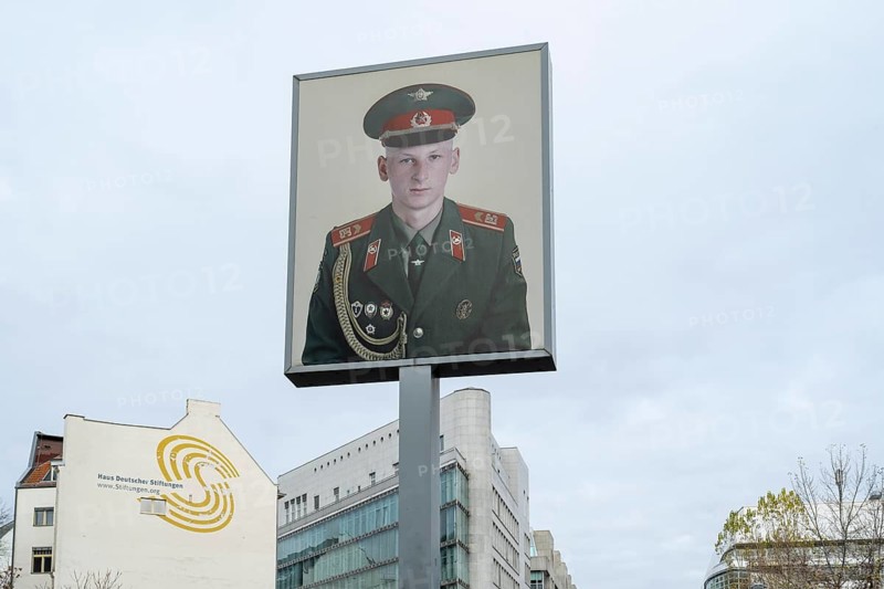 Sign with the portrait of a soldier, Checkpoint Charlie, Mitte, Berlin, Germany