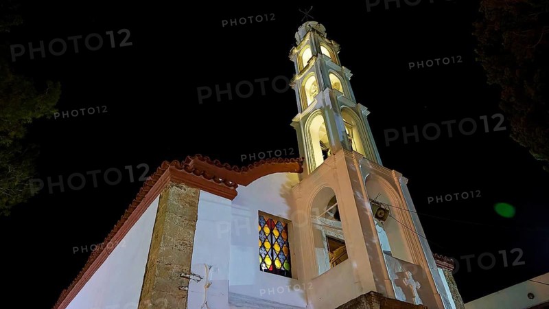 An illuminated church tower rises in the night, its architecture and the coloured windows radiate solemn splendour, church in Psinthos, Easter fire Psinthos, Holy Saturday, Easter, Psinthos, Rhodes, Dodecanese, Greek Islands, Greece