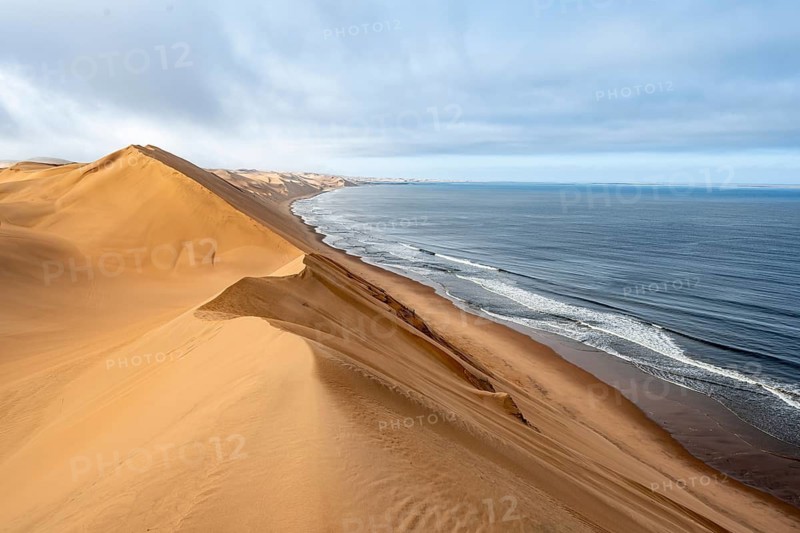 Sand dunes and sea in morning light, Atlantic coast and Namib desert, impressive desert landscape, Sandwich Harbour, Namib Naukluft Park, Namibia