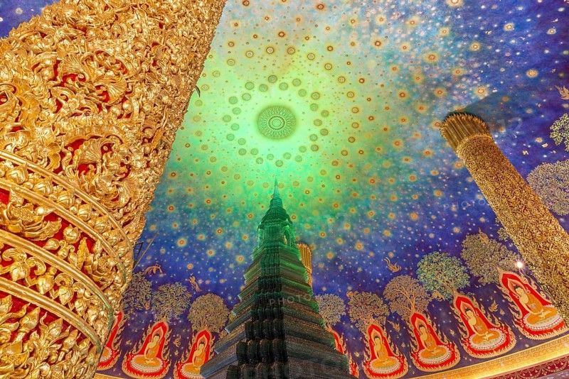 In the emerald green silence of Wat Paknam Phasi Charoen, the glass chedi rises like a glowing heart of light. Golden pillars support a cosmic ceiling that plunges the room into a sense of infinity. The wall paintings tell of Buddha's path to enlightenment and combine earthly beauty with spiritual depth that makes this place so unique, Phasi Charoen district, Thonburi, Bangkok, Thailand