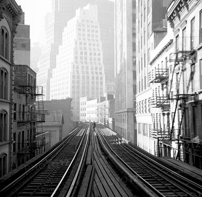 New York, USA, Manhattan, Elevated RR, 3rd Avenue, built in 1878, dismantled in 1955, public transport, view along elevated rails in a foggy city with skyscrapers and urban architecture, Harold Chazen, 1928-2009, around 1950