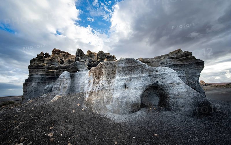 Eroded rock formations, volcanic landscape with dramatic cloudy skies, Ciudad Estratificada or Los Roferos, Antigua Rofera de Teseguite, Lanzarote, Canary Islands, Spain