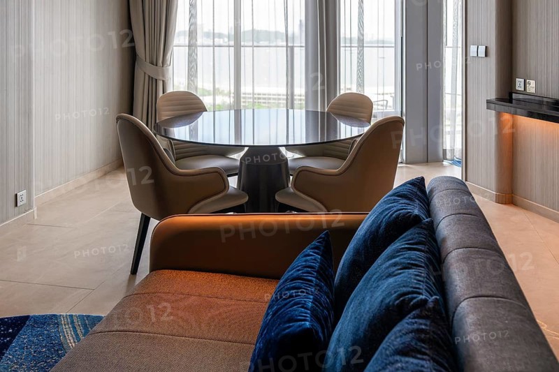 Hotel suite living area with sofa and dining table, Pattaya, Thailand