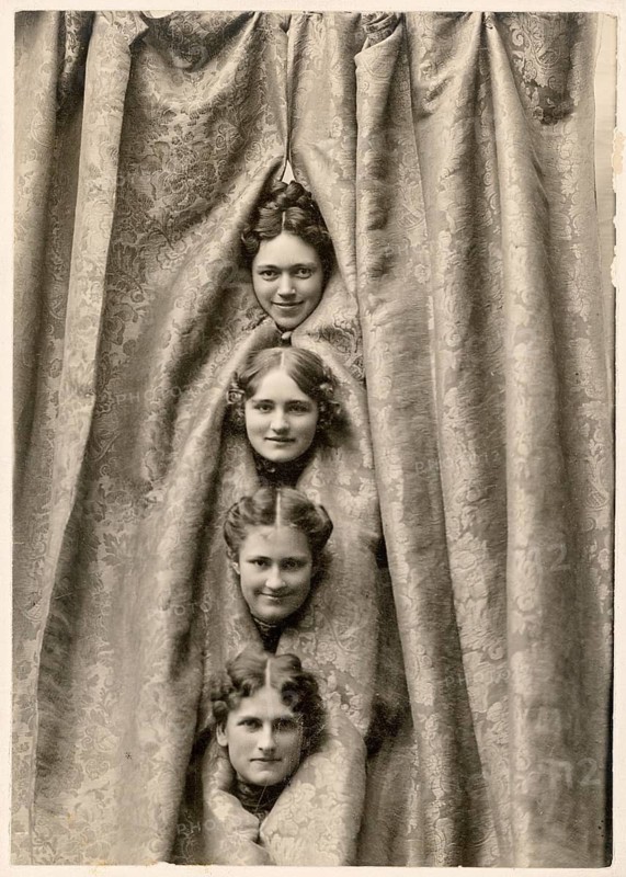 Dancers, cabaret, variety show, humor, curtain, Wheaton, Illinois, USA, four female heads peeking out of a patterned curtain in a stacked pattern, 1897