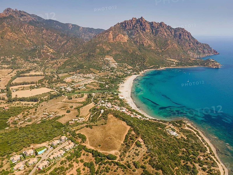 A cloudless blue sky shines over Foxi Manna beach, renowned throughout Europe, in the municipality of Tertenia on the island of Sardinia, Italy. (Aerial view taken by drone), Foxi Manna, Tertenia, Sardinia, Italy