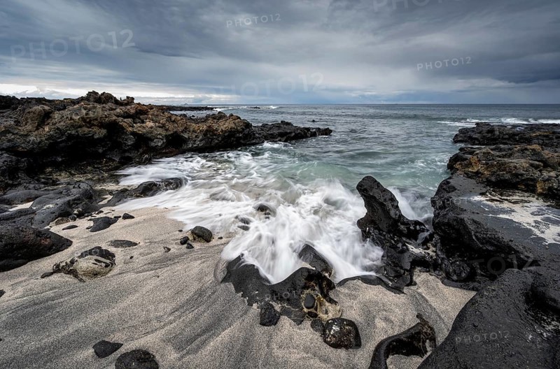 Waves blaze on the beach, rocky coast with volcanic stones, long exposure, Playa de la Pequeña, Punta Usaje, Lanzarote, Canary Islands, Spain