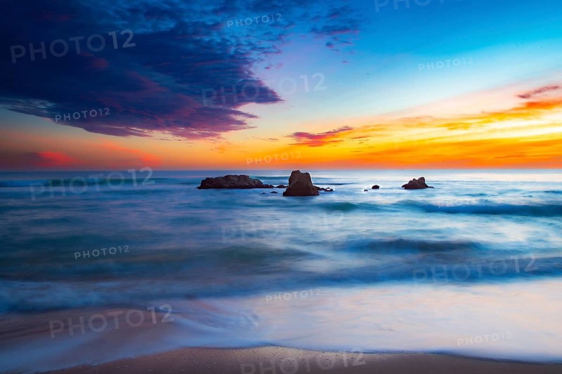Calming sunrise over the ocean with rocks and harmonious colors in the sky, sunset, Praia do Amado, Carrapateira, Algarve, West Coast, Atlantic, Portugal