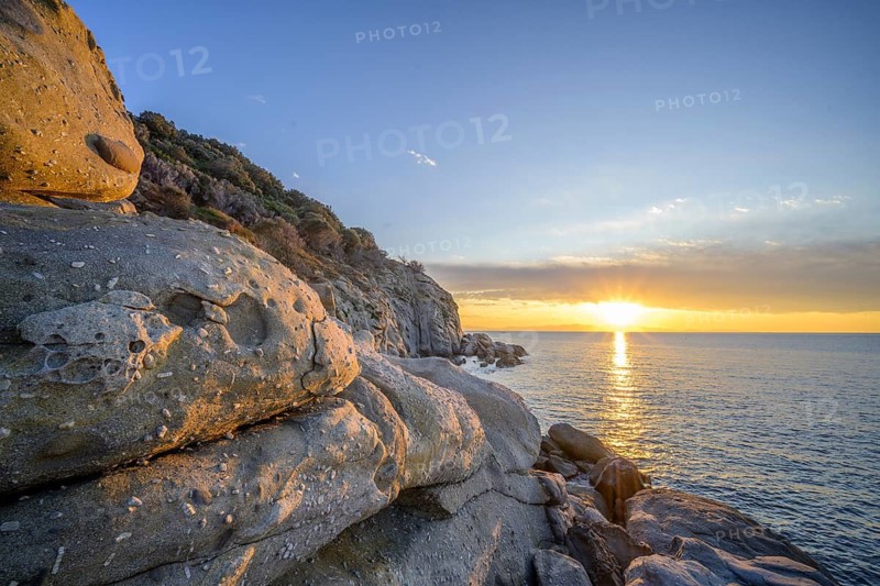 Rock formations in the evening light on, Capo Sant Andrea, Marciana, Livorno Province, Italy