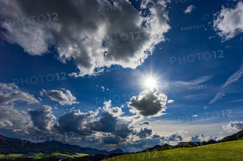 Meadow with dramatic cloudy sky, agricultural landscape, Mondseeland, Salzkammergut, Austria