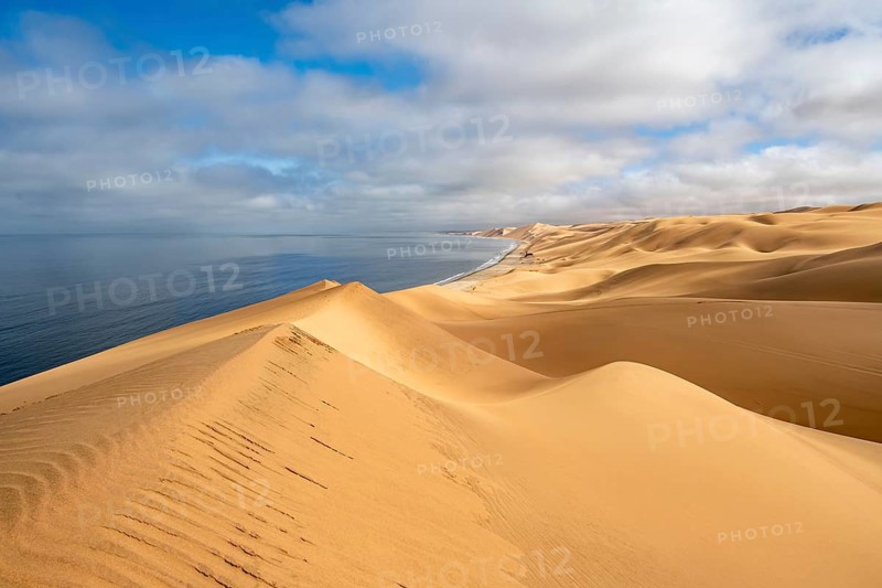 Sand dunes and sea, Atlantic coast and sandy desert with sea of dunes, Sandwich Harbour, Namib Naukluft Park, Namib Desert, Namibia