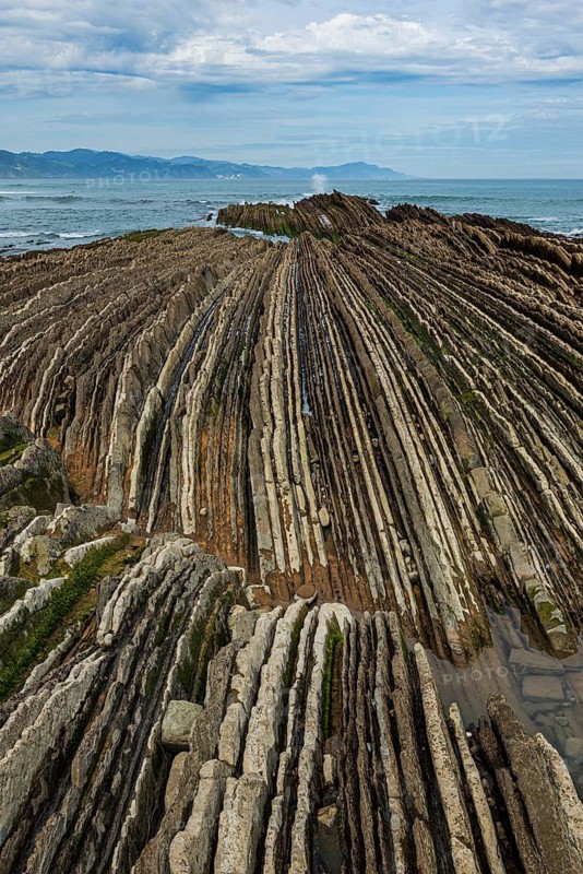 Distinctive rock cliffs as a geological formation of rock layers, Flysch on Itzurun Beach in Zumaia, Spain