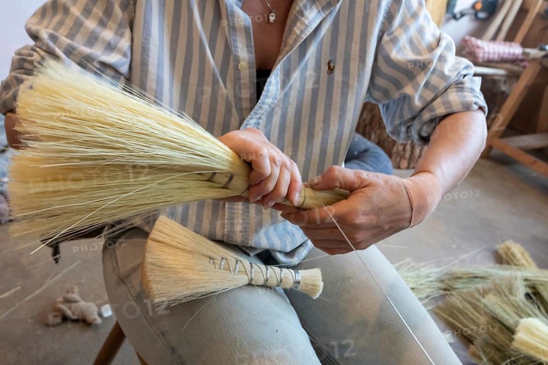 Berea, Kentucky - Cynthia Main makes traditional Appalachian brooms and whiskbrooms by hand at Sunhouse Craft. They use broomcorn, a type of sorghum, and distribute their products through wholesalers and direct to consumers. Cynthia Main is the founder of Sunhouse Craft