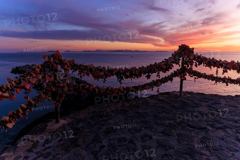 Lanzarote, Canary Islands, Spain, Europe, Playa Blanca, Love Castles, A coastal landscape with love locks and a magnificent sunset sky