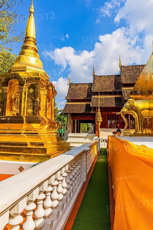 Gilded temple tower, chedi, stupa, and gilded elephant statue in the Wat Phra Singh Buddhist temple complex, Chiang Mai Old City Center, Chiang Mai Province, Thailand