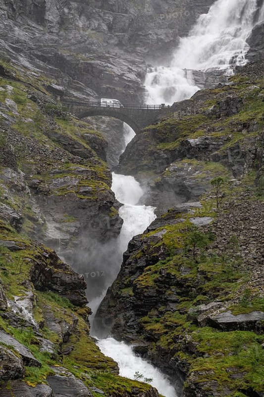 Motorhome on a bridge in front of heavily swollen Stigfossen waterfall, Trollstigen, near Åndalsnes or Andalsnes, Rauma municipality in the province of Møre og Romsdal, Norway