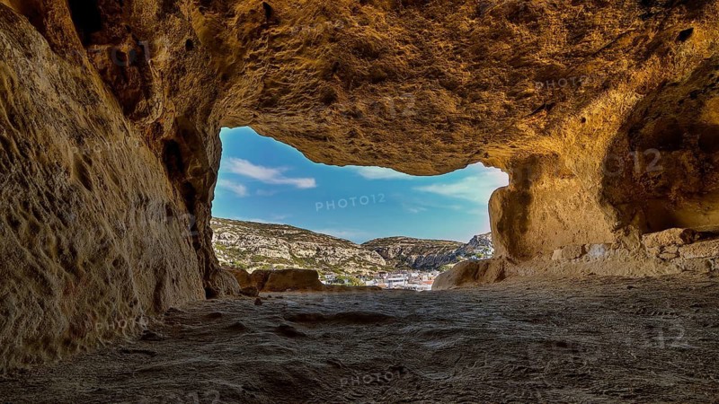 Sky changed, Neolithic caves, former hippie paradise, view from a reddish brown cave of the surrounding landscape and clear sky, Matala, south coast, Crete, Greek islands, Greece