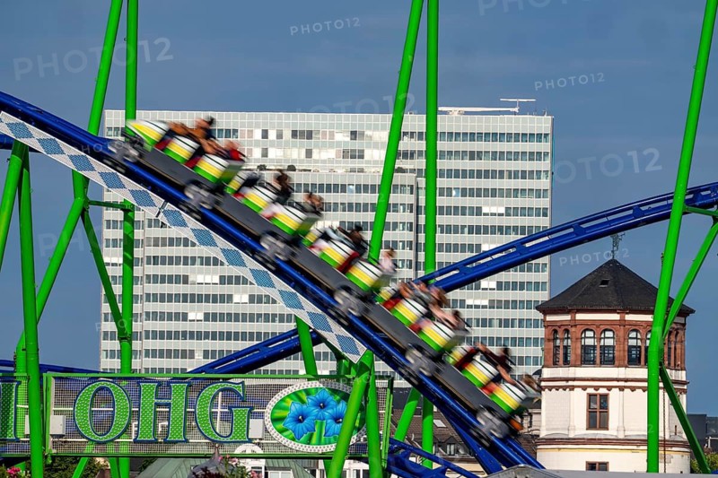Achterbahn, Alpina Bahn, at the Rheinkirmes in den Rheinwiesen in Düsseldorf-Oberkassel, Dreischeibenhaus, Schlossturm, North Rhine-Westphalia, Germany