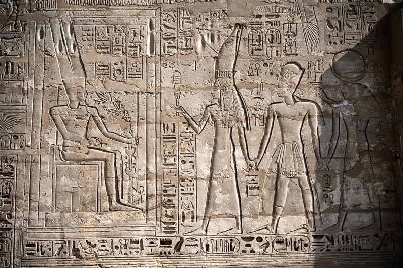 Close up details of ancient Egyptian history shown in reliefs and hieroglyphs inside Medinat Habu, the ancient Egyptian Mortuary Temple of Ramesses III on the West Bank of The Nile, Luxor, Egypt