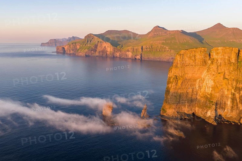 The Risin og Kellingin pinnacles off the Eysturoy cliffs in the evening light, Faroe Islands, Denmark