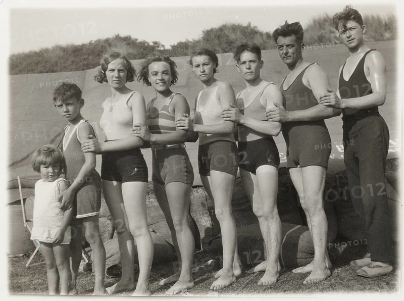 Bathing, swimwear, leisure, summer, woman, men, girls, boys, children, a group of people standing next to each other in bathing suits and looking at the camera, a sense of community, around 1930