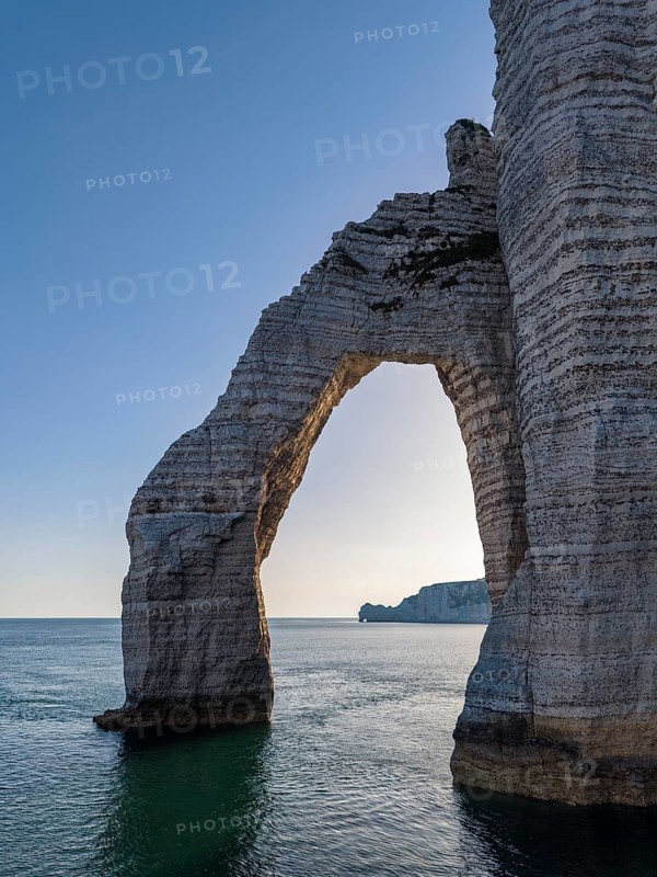 Aerial view of Porte d'Aval rock gate in backlight, famous sights and natural beauty on the chalk coast, Étretat, Alabaster Coast, La Côte d'Albâtre, chalk cliffs, English Channel, Seine-Maritime, Normandy, France