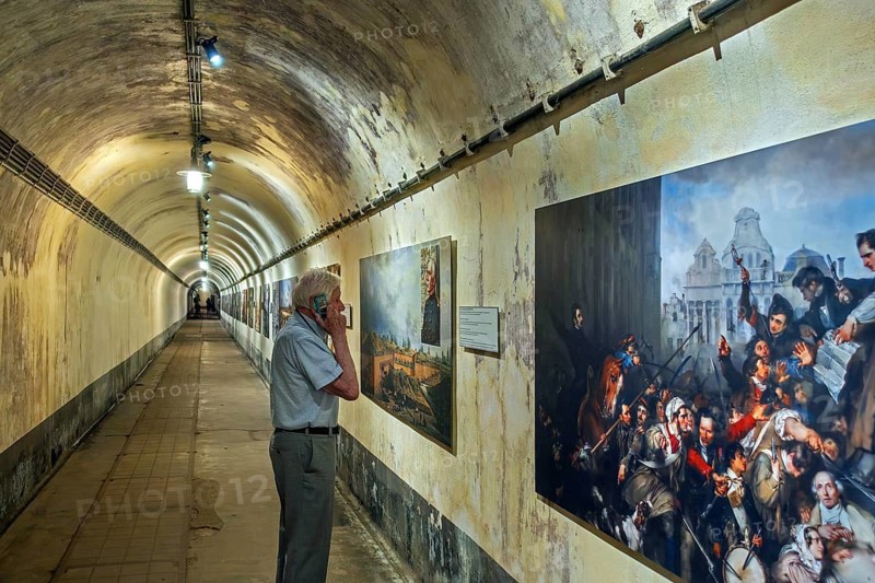 Visitor in underground corridor at Fort Eben-Emael, Belgian WW2 fortress neutralized by German paratroopers during the Second World War Two in Belgium. Model released
